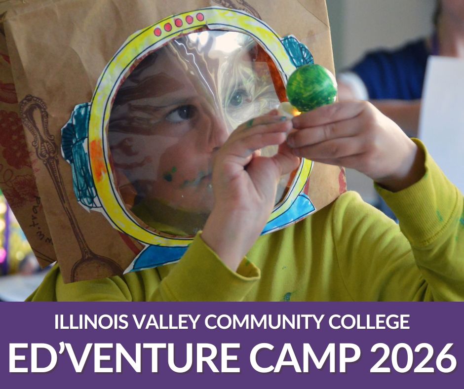 Boy looking at small planet craft project with paperbag astronaut hat on his head