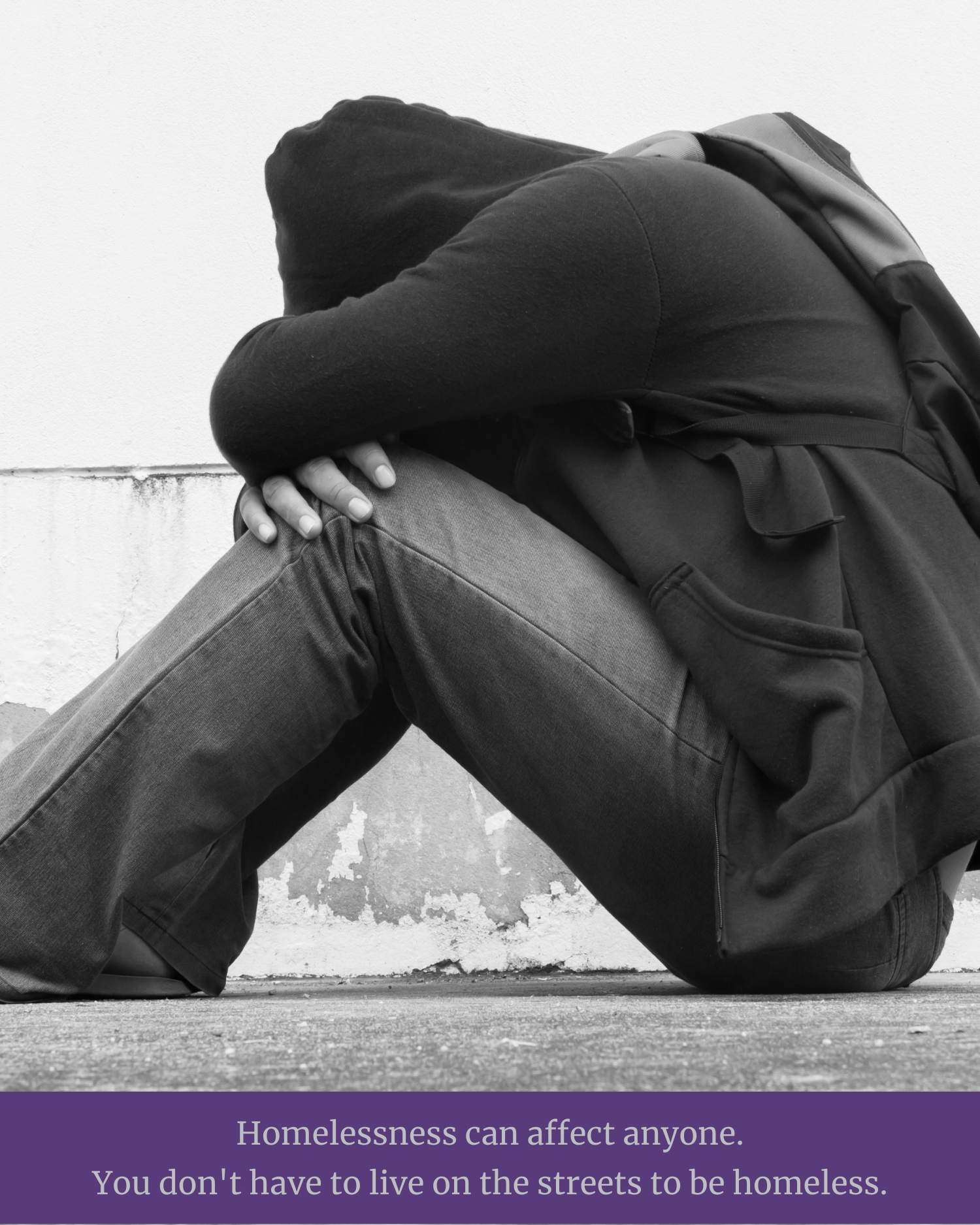 distressed homeless student with head in lap